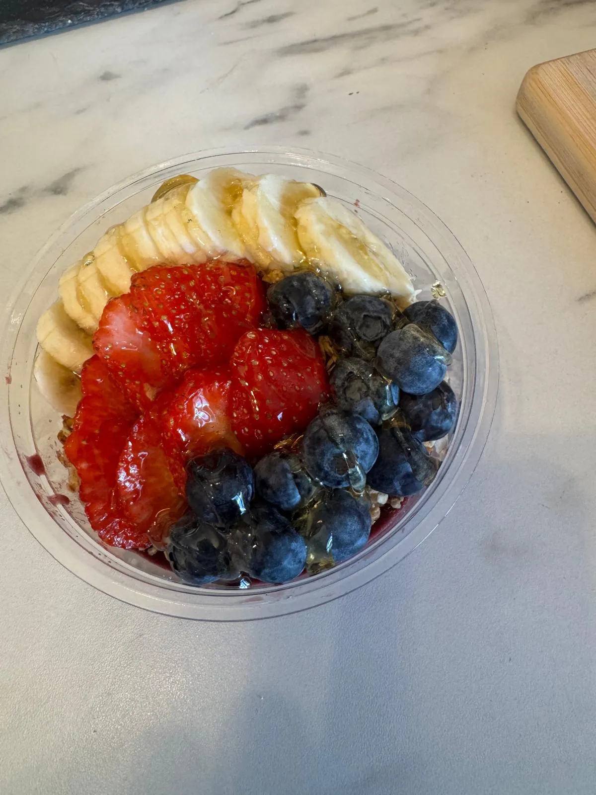 A loaded açaí bowl topped with fresh fruit and granola